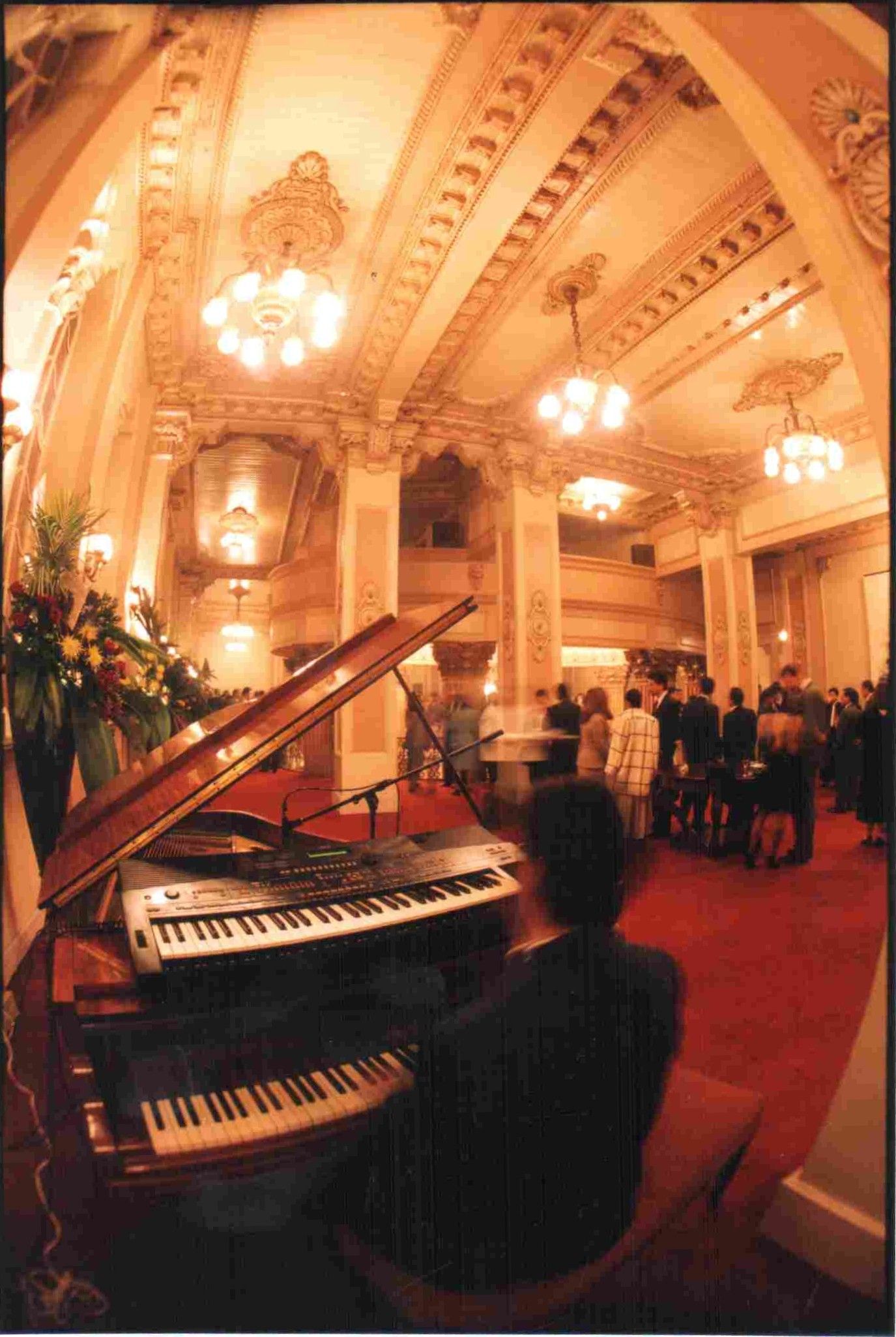 Salón con piano y lámparas de época